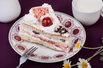 Cake with cherry with cup of milk