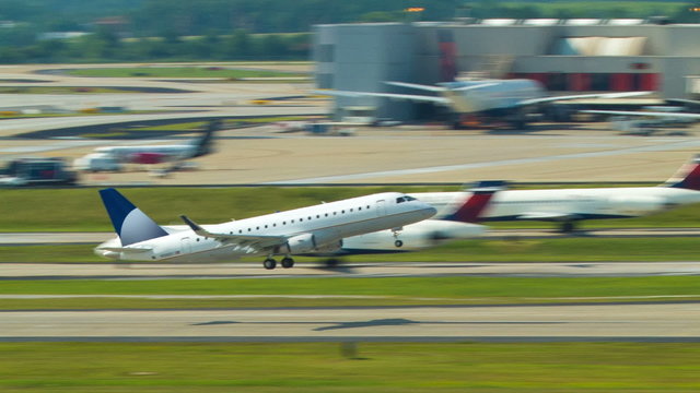 Generic Embraer Jet Commercial Airliner Taking Off from the Worlds Busiest Airport ATL into a Clear Blue Sky on a Sunny Day in Atlanta.