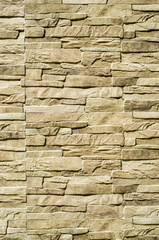 Fototapeta premium Decorative relief cladding slabs imitating stones on wall