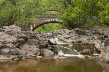 Fototapeta na wymiar Stone Arch Bridge & Creek Scenic