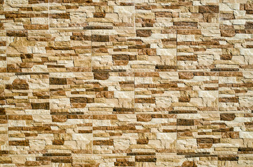 Decorative relief cladding slabs imitating stones on wall