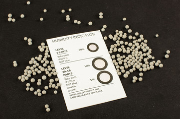 Humidity indicator card and humidity absorber desiccant bubbles isolated on the black background