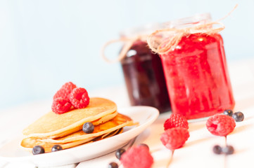 Breakfast food. Pancakes with jam and raspberries. Unique