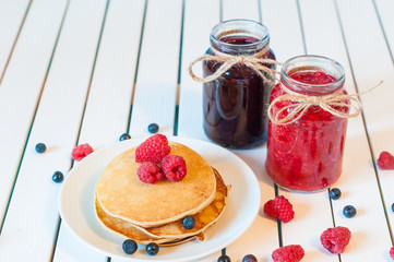 Breakfast food. Pancakes with jam and raspberries. 