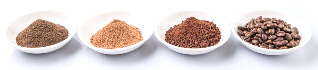Coffee beans, powdered coffee, chocolate powder and processed tea leaves beverages in white bowl over white background