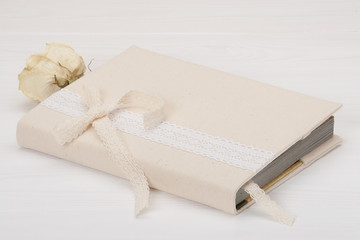 Notebook With Natural Linen Cover. Dried Rose. White Wooden Back