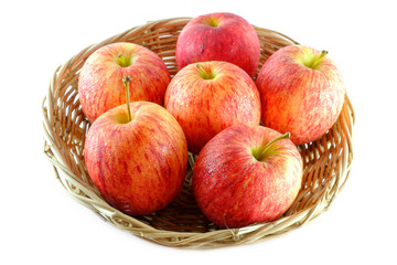 Fresh of apples on a basket isolated on white background