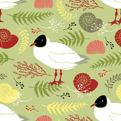 Gulls on the coast with shells, twigs and leaves