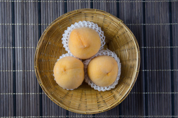 Peach rests on the foam in a basket.