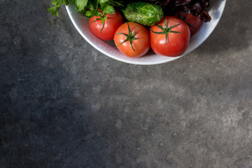 Freshly harvested organic vegetables  on a gray background