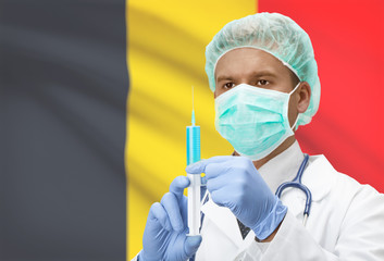 Doctor with syringe in hands and flag on background series - Belgium