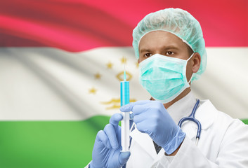Doctor with syringe in hands and flag on background series - Tajikistan