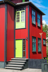 Red house with green door seen in Reykjavik, Iceland