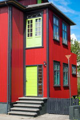 Fototapeta premium Red house with green door seen in Reykjavik, Iceland