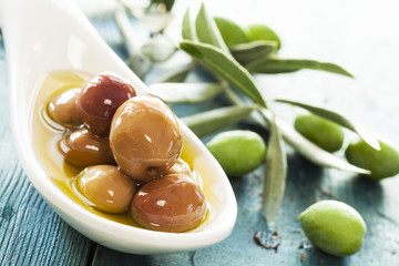 Green olive in bowl and olive branch