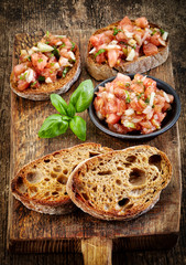 bruschettas ingredients on wooden cutting board