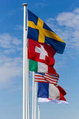 Several flags of different countries on the background of blue s