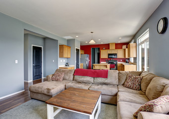 Modern living room with beige sofa and gray walls.