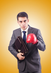 Young businessman with boxing gloves