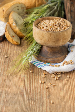 Ears of barley flour, bread on a wooden background
