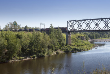 The train drives on the bridge through the river Narva. Estonia.
