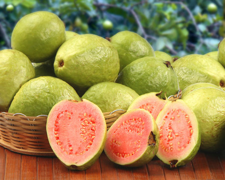 Some brazilian guavas over a striped surface.