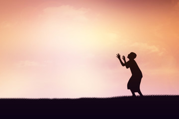 Human hand side above the background sky orange.