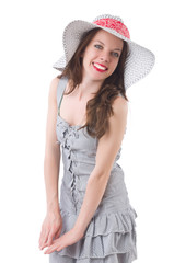 Young woman wearing hat and gray striped dress isolated on white