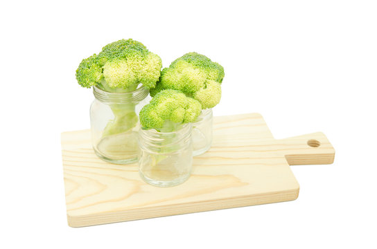 Green cabbage broccoli flower in glass bottles