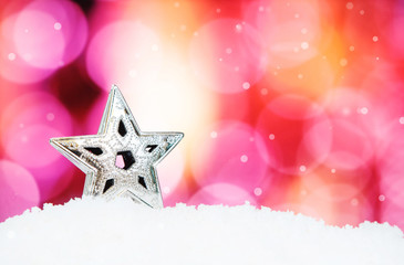 Star and christmas decoration on abstract background and snowfla
