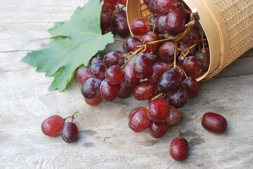 Red grapes on a wooden floor