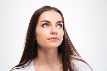 Fototapeta premium Cute pensive woman looking up