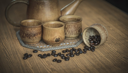 Vintage photo of coffee beans and Coffee cups set on wooden back