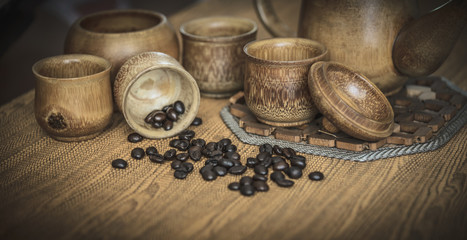 Vintage photo of coffee beans and Coffee cups set on wooden back