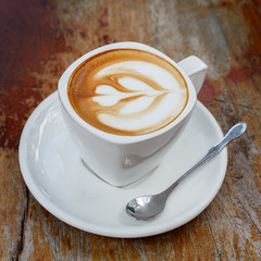 Cup of latte coffee on wooden table