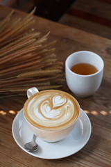 Cup of latte coffee with tea
