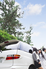 Fototapeta premium 車の前に立つ学生たち