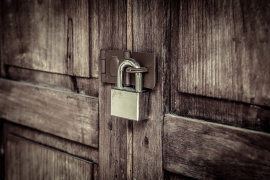 locked wooden door with silver padlock