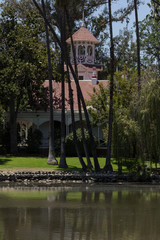 Editorial - Queen Anne Cottage in front of a pond at the Historical Los Angeles Arboretum and...