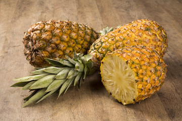 Some pineapples over a wooden table