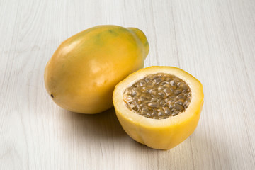 Close up of some passion fruits over a wooden surface seen from