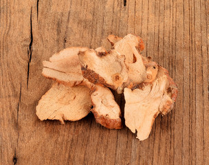 Dried galangal on wooden background