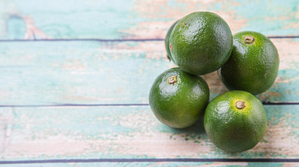 Calamansi citrus over weathered wooden background