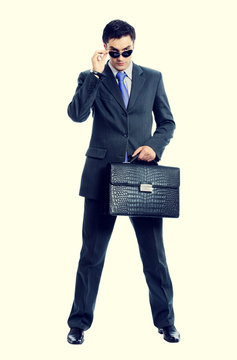Businessman or hacker in sun glasses with briefcase