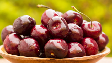 Close up of some cherries on a green and natural background