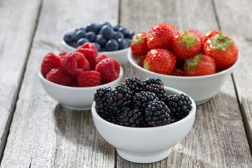 Fresh juicy garden berries on wooden table