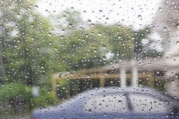 Rain drops on the other side of the glass. With the coming of th