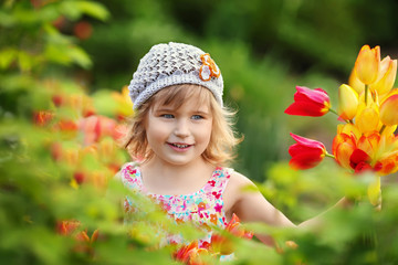 Beautiful little girl with a bouquet of flowers