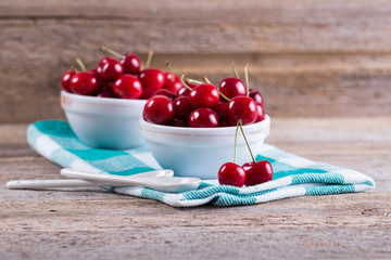 Cherries in a bowl on the table. The view from the top. Crop, orchard, berries. Healthy nutrition. Ripe berries. In the kitchen. Diet. Delicious berries. Shiny red berries.