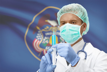 Fototapeta premium Doctor with syringe in hands and US states flags on background series - Utah